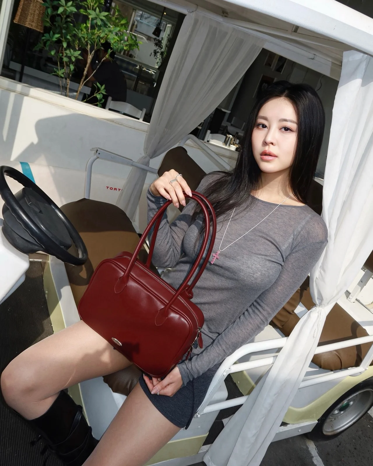 &nbsp;     Burgundy Boston bag details — double top handles and side-zip structure / Photo: model Sim Ji-young\'s Instagram