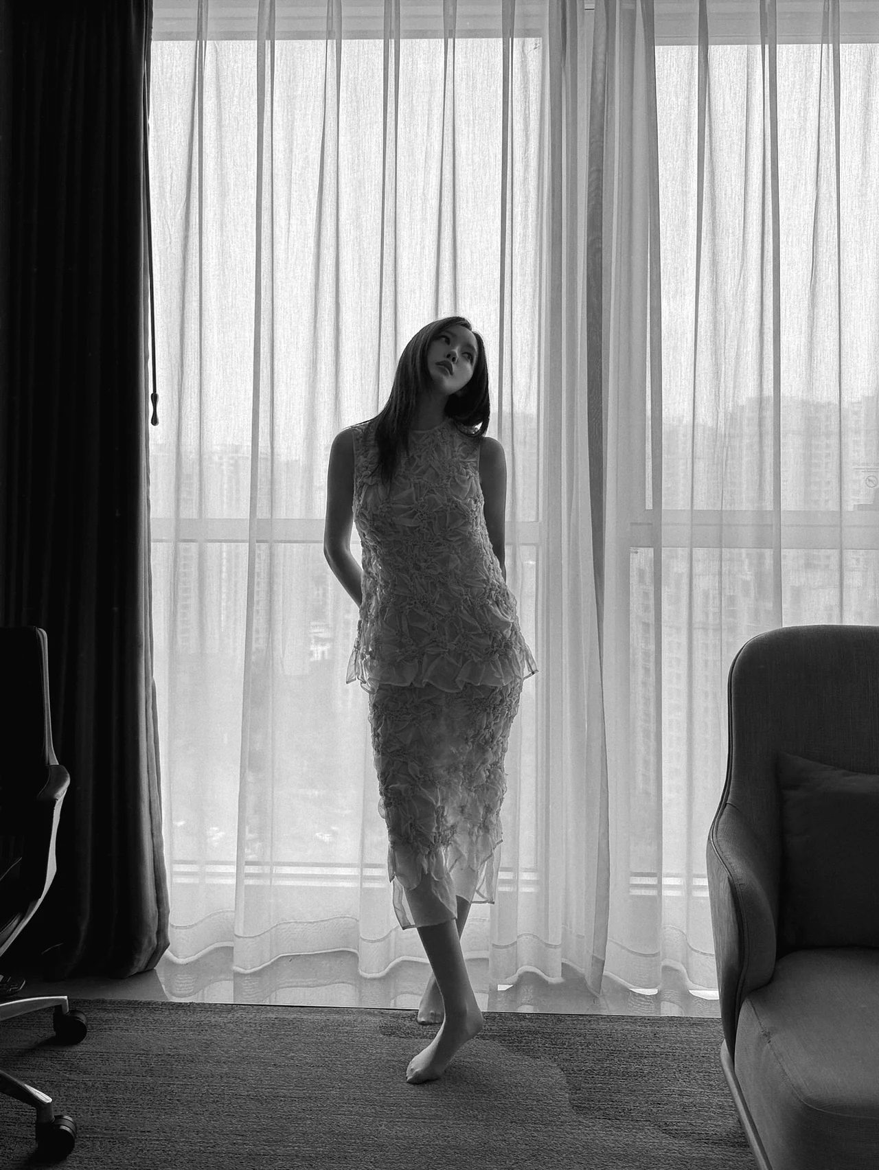&nbsp;     Black-and-white worn shot in front of a backlit curtain, where the ruffle texture’s contrast comes alive / Photo: Hyomin\'s Instagram