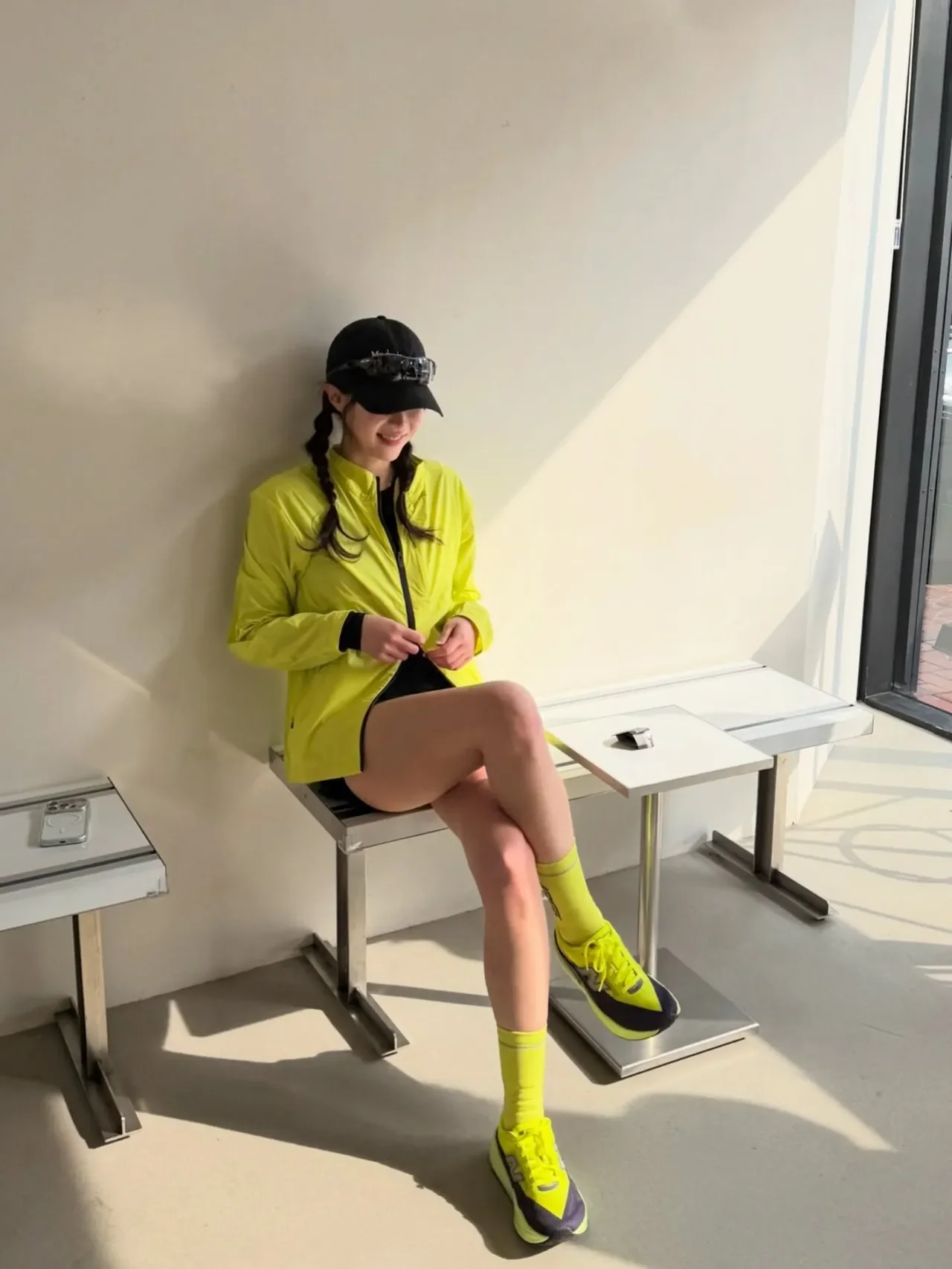 Im Soo-hyang models a runner look on a Han River bridge in a KALEG neon-yellow running jacket and a black cap. /Photo = Im Soo-hyang Instagram