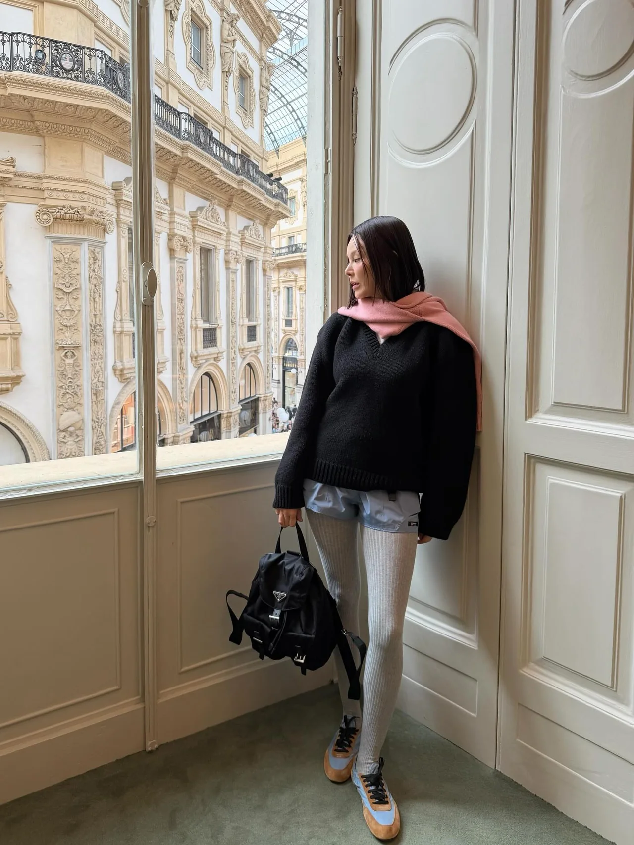 Black V‑neck knit look | A natural everyday outfit finished with a pink scarf and nylon backpack / Photo: Ivy’s Instagram