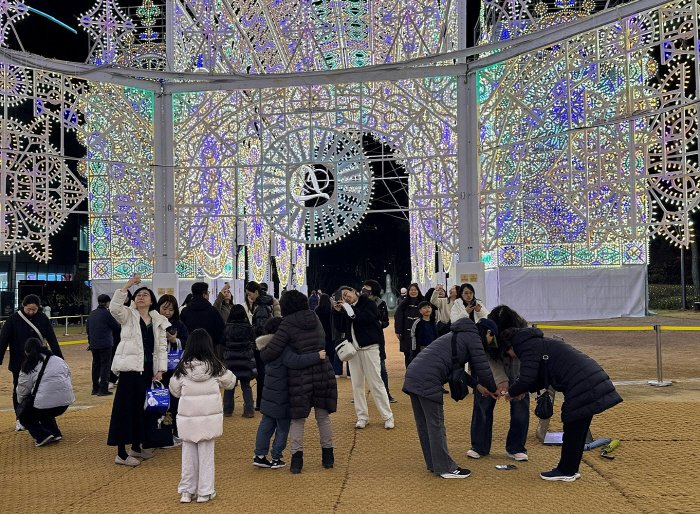 루미나리에 관람객들이 휴대폰을 바닥에 내려놓고 ‘바닥 셀카’를 촬영하고 있다.