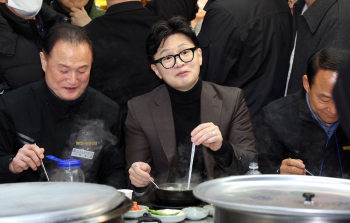 한동훈 국민의힘 전 대표가 7일 부산 북구 구포시장을 방문해 상인 대표 등과 국밥을 먹고 있다.ⓒ뉴시스
