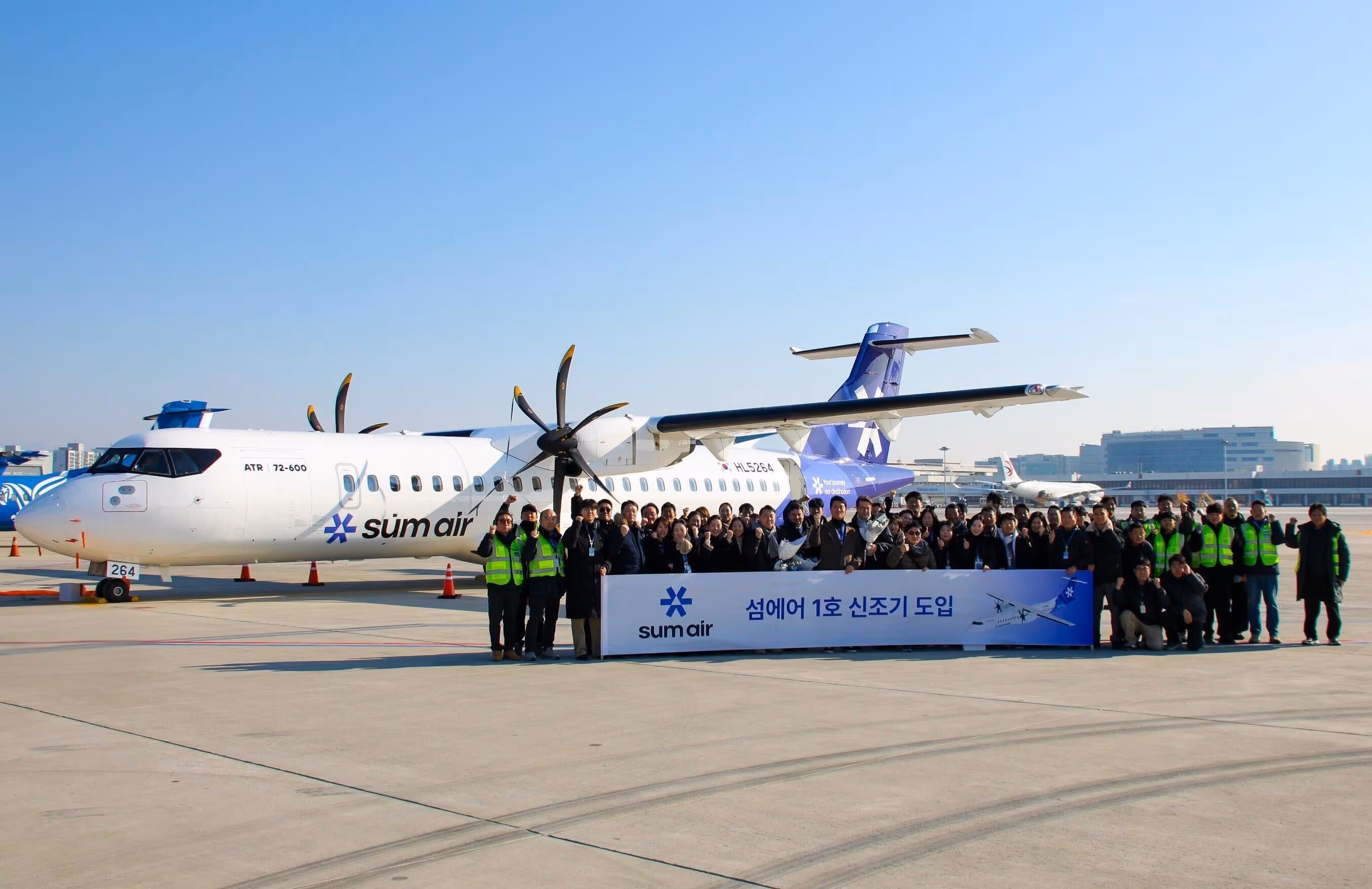 SeomAir staff pose for a commemorative photo in front of the carrier’s first aircraft after its arrival at Gimpo Airport. /Courtesy of SeomAir