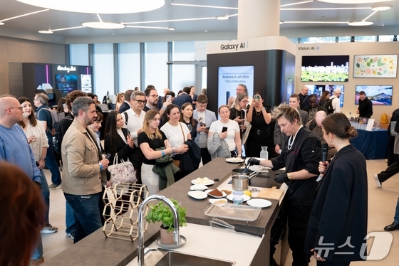 Attendees are trying out the new integrated hood induction cooktop at Samsung Electronics\' home appliance technology seminar, The Brief Milan, held in Milan, Italy, on Tuesday / Provided by Samsung Electronics