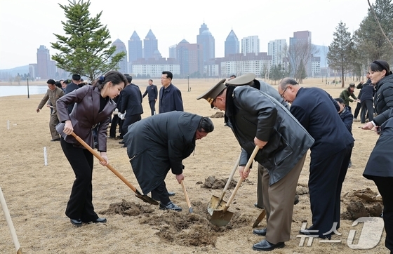 North Korean leader Kim Jong Un plants a tree with his daughter Ju Ae at Saebyeol Street pond park on March 14, marking Arbor Day. Kim Yo Jong, Workers’ Party Department Director, is seen at the far right. [For Use Only in the Republic of Korea. Redistribution Prohibited] / Courtesy of News1