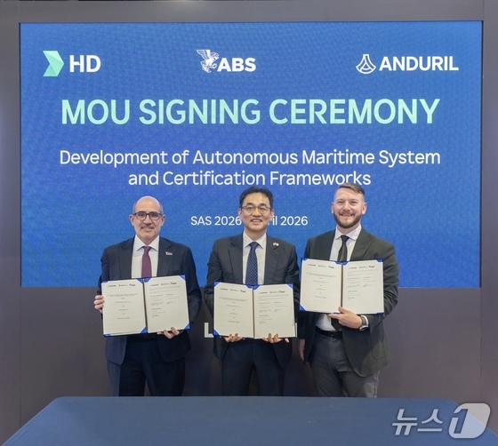 At the HD Hyundai exhibition hall during the Sea Air Space 2026 (SAS 2026) exhibition held in Washington, D.C., on Wednesday, (from right) Cory Emmons, Head of the Surface Vessel Business Division at Anduril; Jang Kwang-pil, Executive Vice President and Director of the Future Technology Research Institute at HD Korea Shipbuilding & Offshore Engineering; Paul Karam, Executive Vice President of Operations at the American Bureau of Shipping (ABS), pose for a commemorative photo after signing a Tripartite Memorandum of Understanding (MOU) on the Development of Autonomous Marine Systems and Related Regulatory and Certification Frameworks (Provided by HD Hyundai) 2026.4.22