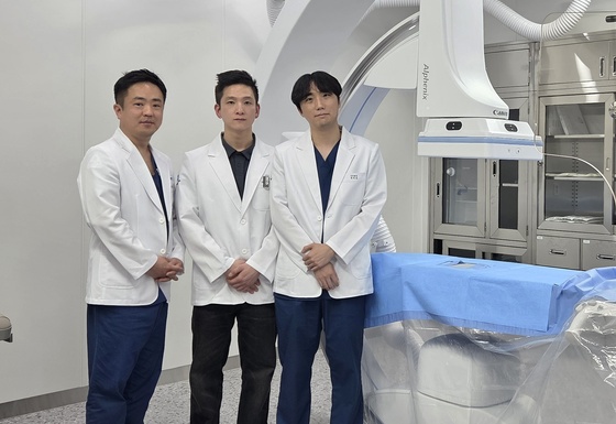 Dr. Kim Tae-sung, Director of Helix Animal Medical Center (from left), Dr. Go Jae-eun, Director of the Seoul Animal Oncology Center, and Dr. Jeong Jeong-yun, Director of the Intervention Center, pose for a photo in front of the angiography equipment used for interventional procedures after an interview / News1