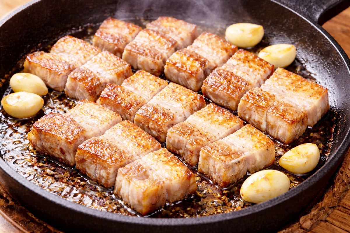 Perfectly grilled pork belly (samgyeopsal). AI-generated stock photo for illustration; actual appearance may vary.