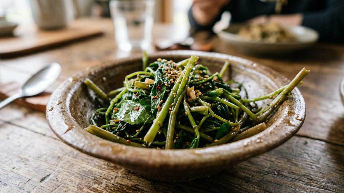 &nbsp;  A bowl of stir-fried water spinach. This image was AI-generated. / Wikitree