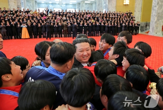 Kim Jong Un, General Secretary of North Korea\'s Workers\' Party, meets with the women\'s soccer players and coaches who won the FIFA Under-17 (U-17) World Cup / Rodong Sinmun