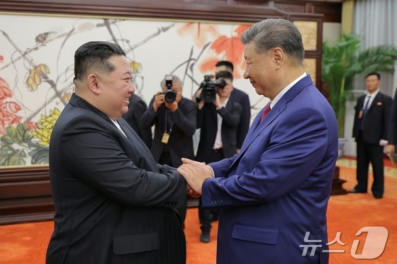 (Pyongyang Rodong Sinmun=News1) = Kim Jong-un, the General Secretary of the Workers' Party of North Korea, is greeting Xi Jinping, the President of China, ahead of their meeting at the Great Hall of the People in Beijing on September 4 last year. [For Use Only in the Republic of Korea. Redistribution Prohibited