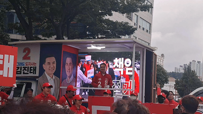 김진태 국민의힘 강원특별자치도지사 후보가 23일 오후 강릉 월화거리에 세워진 유세차에서 선거송에 맞춰 동작을 하고 있다. ⓒ데일리안 김은지 기자