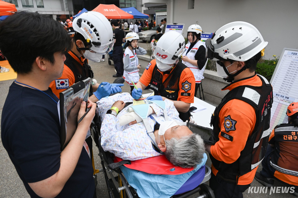 19일 한양대학교병원에서 진행된 ‘2026년 재난대응 안전한국훈련’에서 구조대가 부상당한 환자를 구급차에 태우고 있다.