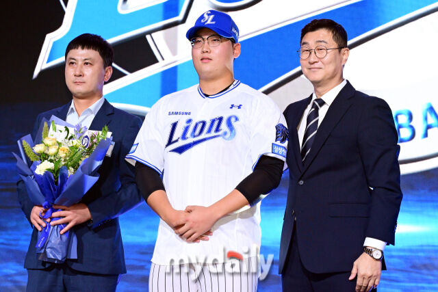 광주진흥고 추수 김민훈이 21일 오후 서울 잠실동 롯데호텔 월드 크리스탈볼룸에서 진행된 ‘2027 KBO 신인드래프트’ 1라운드에서 삼성 라이온즈에 지명된 뒤 이종률 구단 단장과 함께 포즈를 취하고 있다./곽경훈 기자